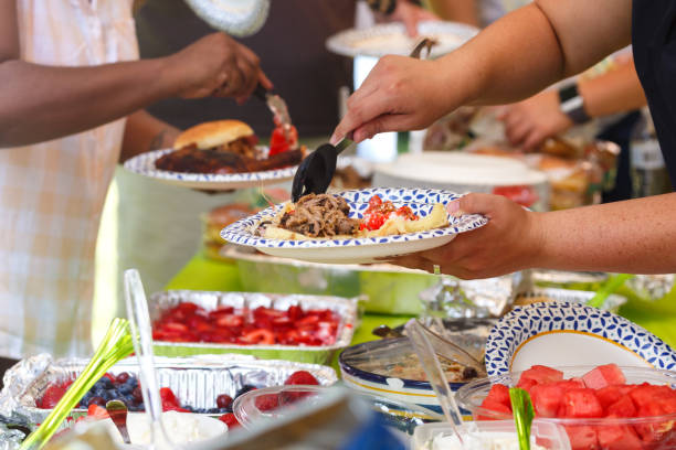 Guests filling plates at a summer cookout